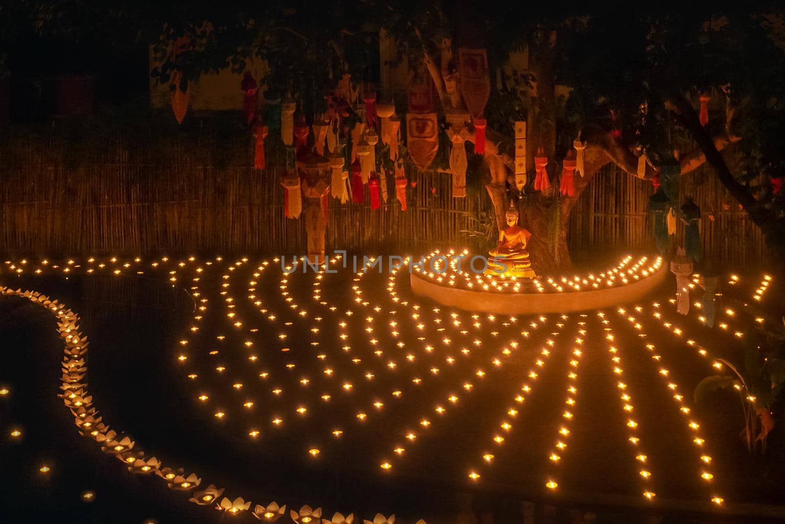 Loy Krathong festival ,Buddhist monk light candles to the Buddha in Phan-Tao Temple, Chiangmai, Thailand. by toa55