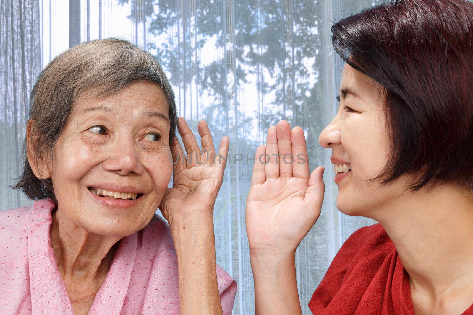 Asian seniors woman hearing loss , Hard of hearing try to talk with daughter. by toa55