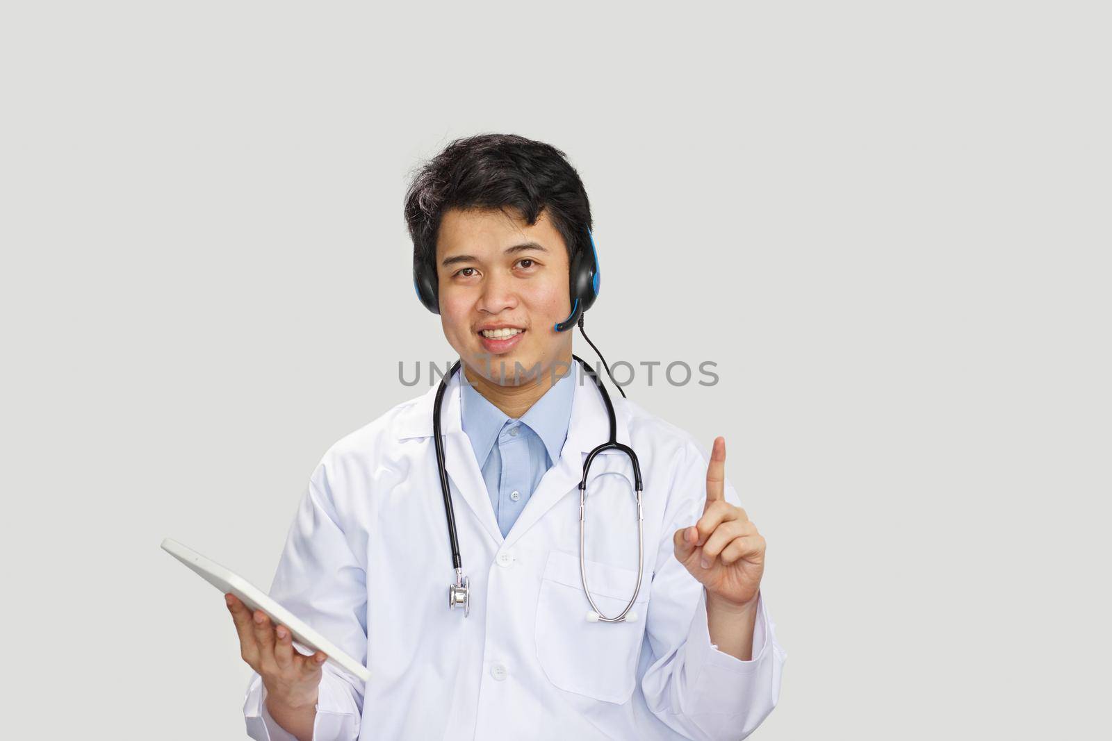 Young asian doctor with stethoscope talking with patient on white background by toa55