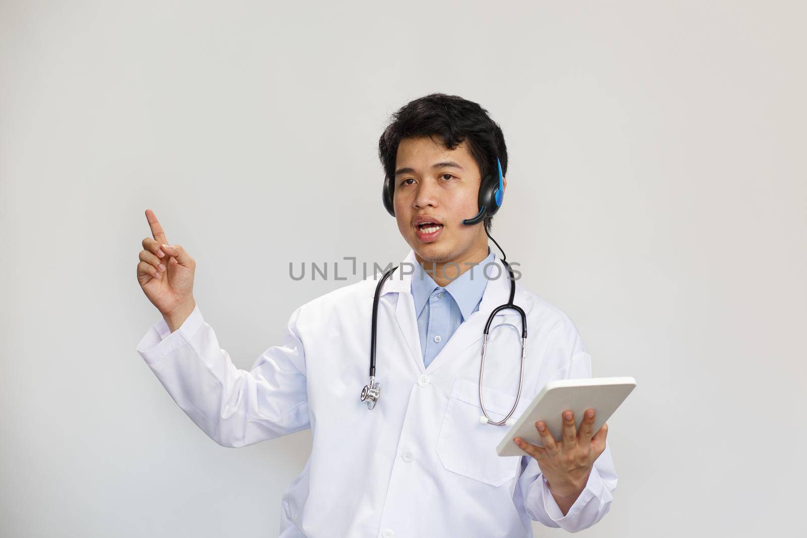 Young asian doctor with stethoscope talking with patient on white background by toa55