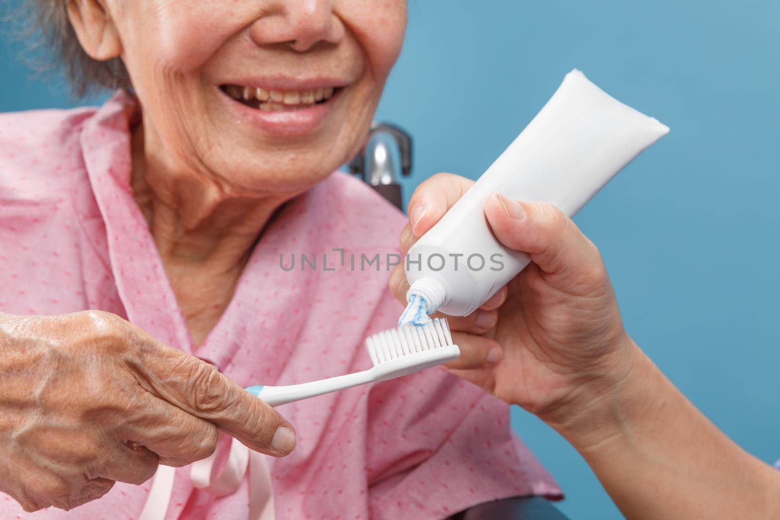 Caregiver take care asian elderly woman while using toothbrush. by toa55