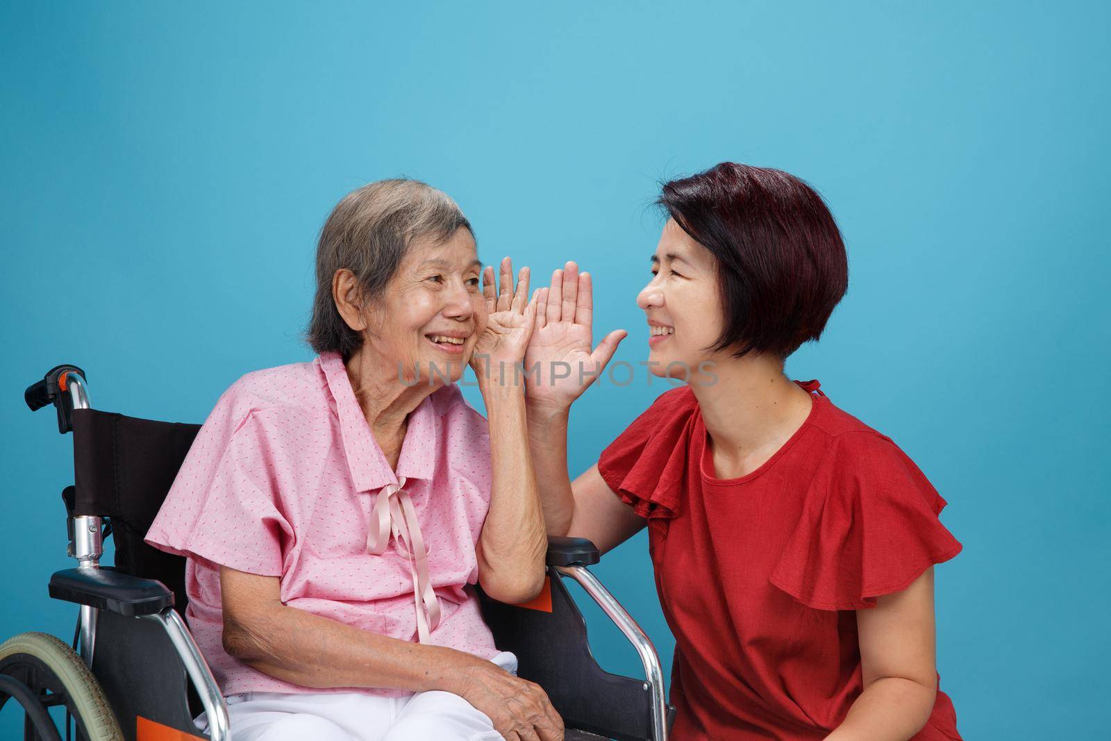 Asian seniors woman hearing loss , Hard of hearing try to talk with daughter.