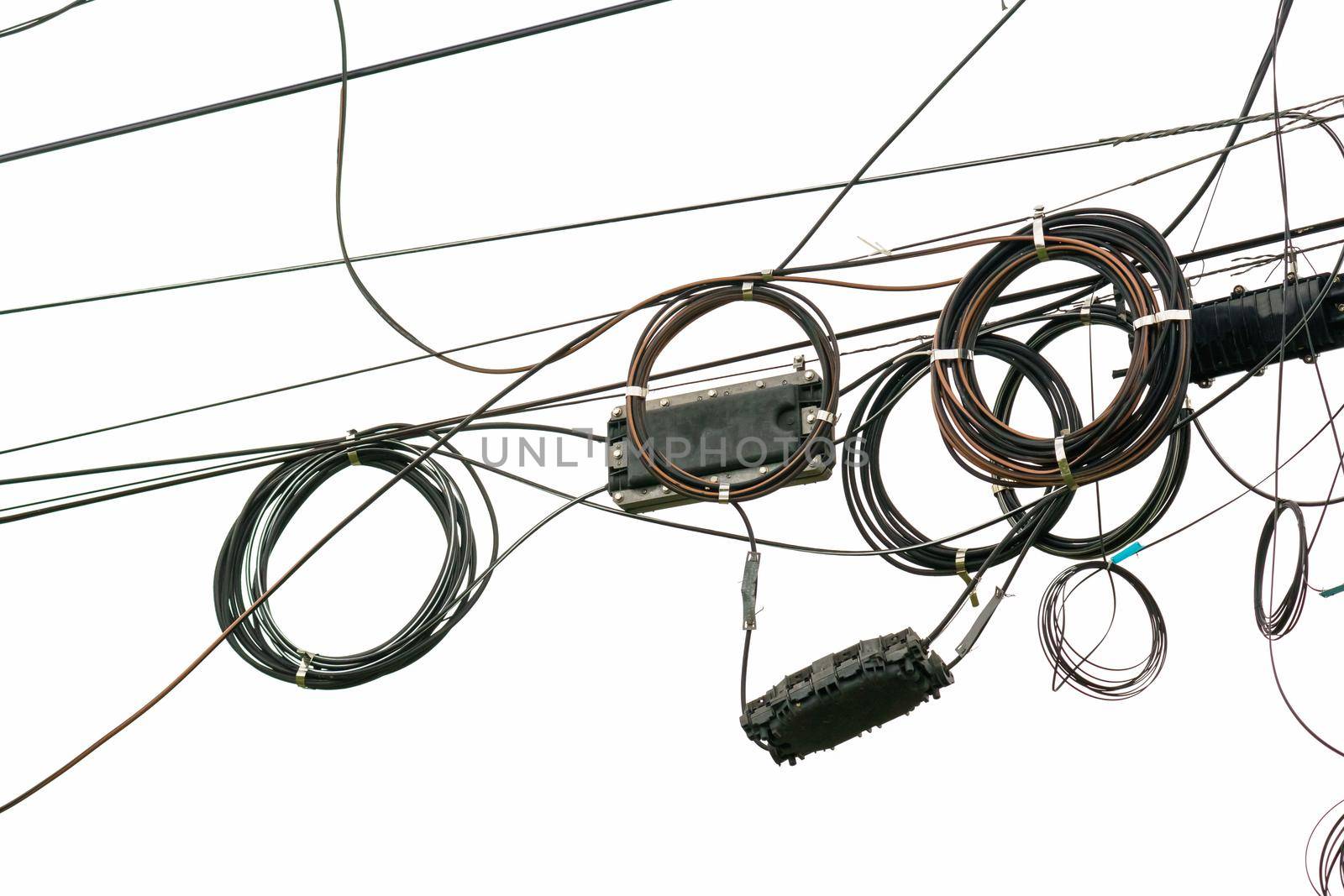 Cable wires on the electric poles are tangled on white  background , Bangkok Thailand.