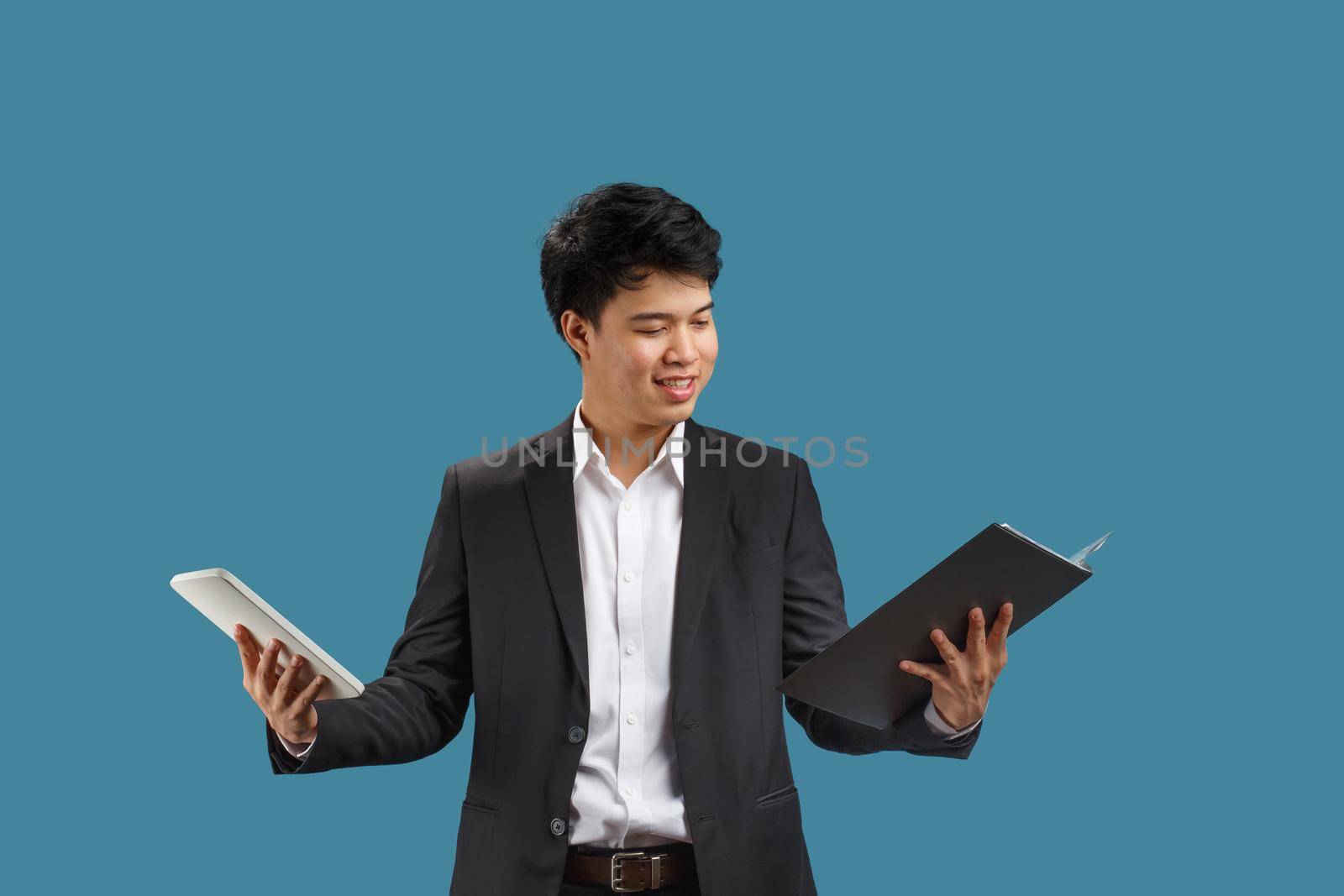 Confused young business man reading document