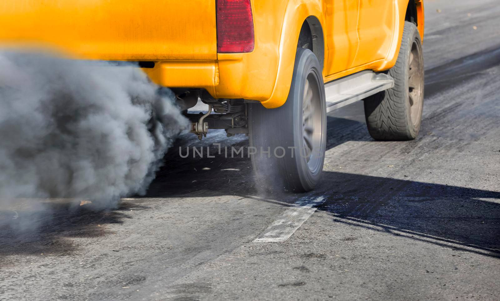 Air pollution from vehicle exhaust pipe on road by toa55