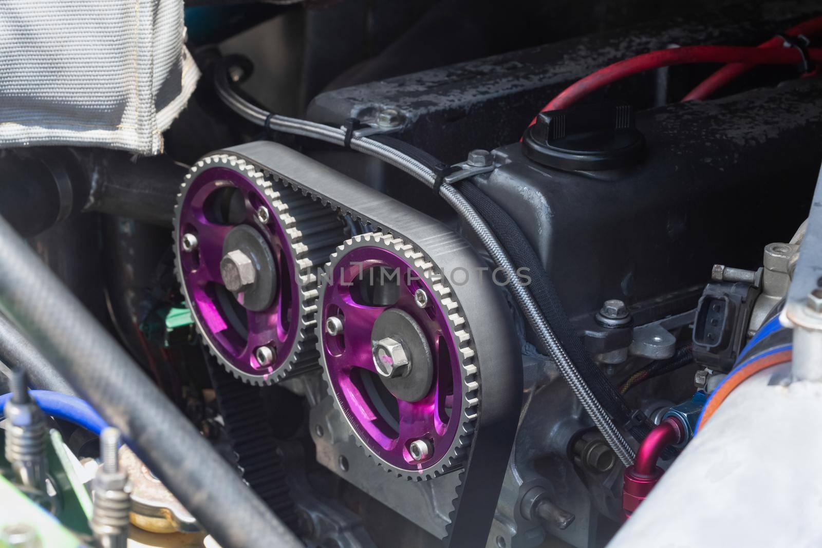 Timing belt and twin camshaft sprocket in engine racing car.