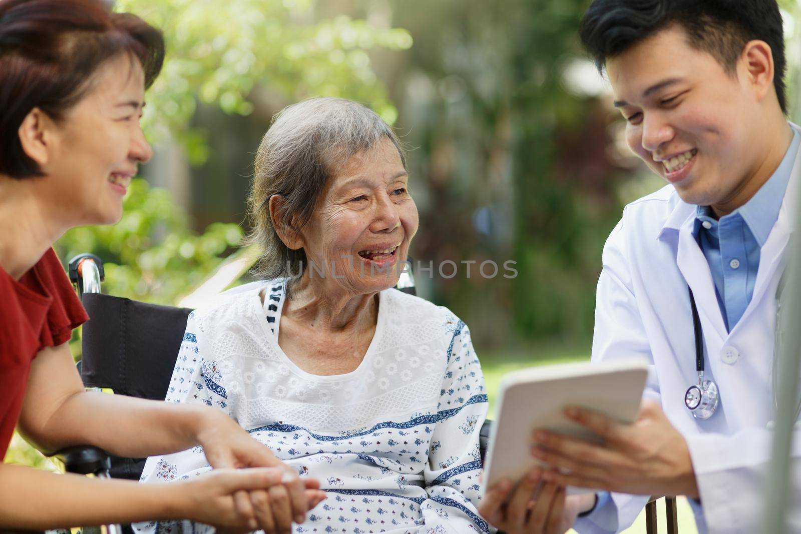  Asian doctor talking with elderly female patient on wheelchair by toa55