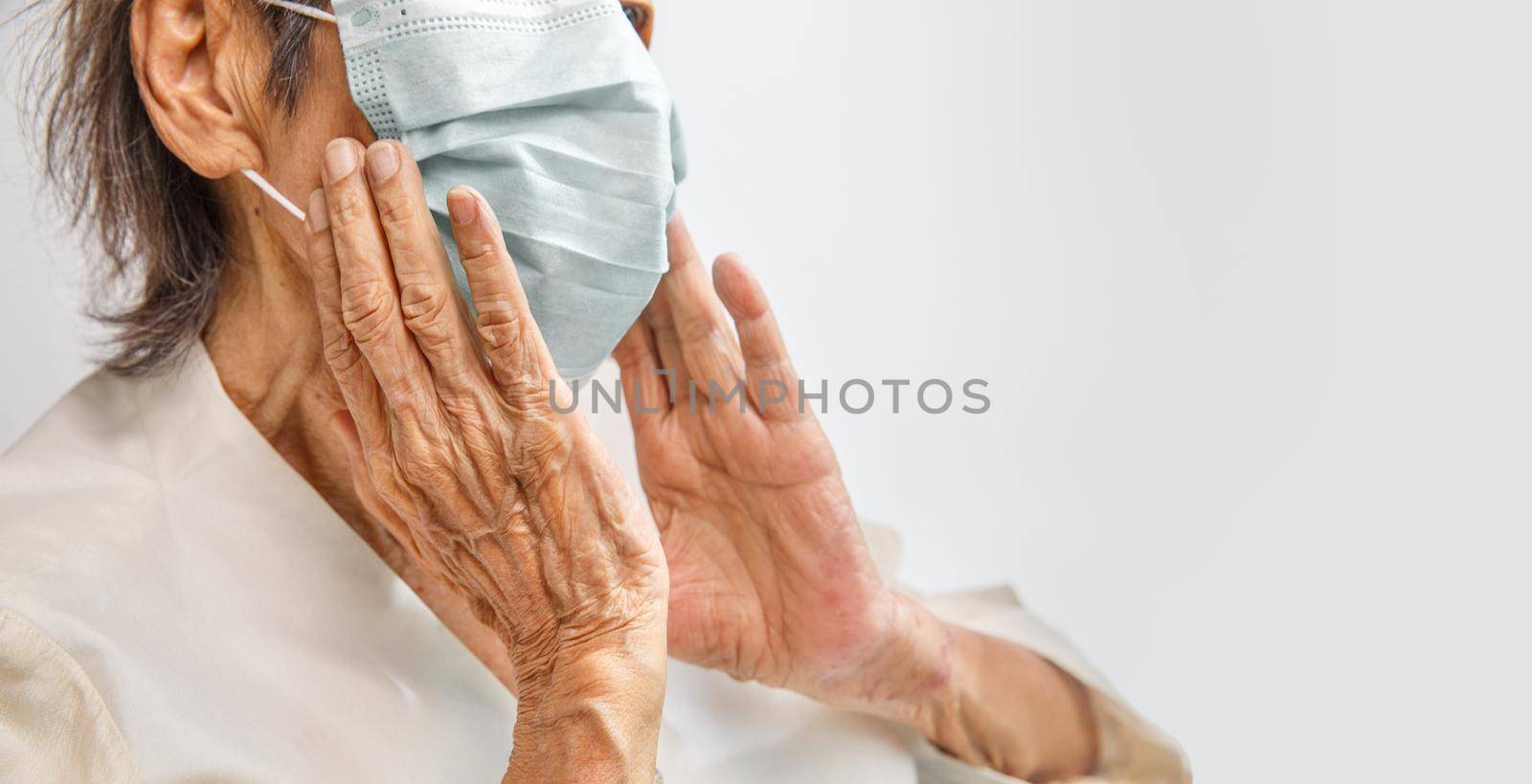 Elderly woman wearing a mask to protect from coronavirus covid-19