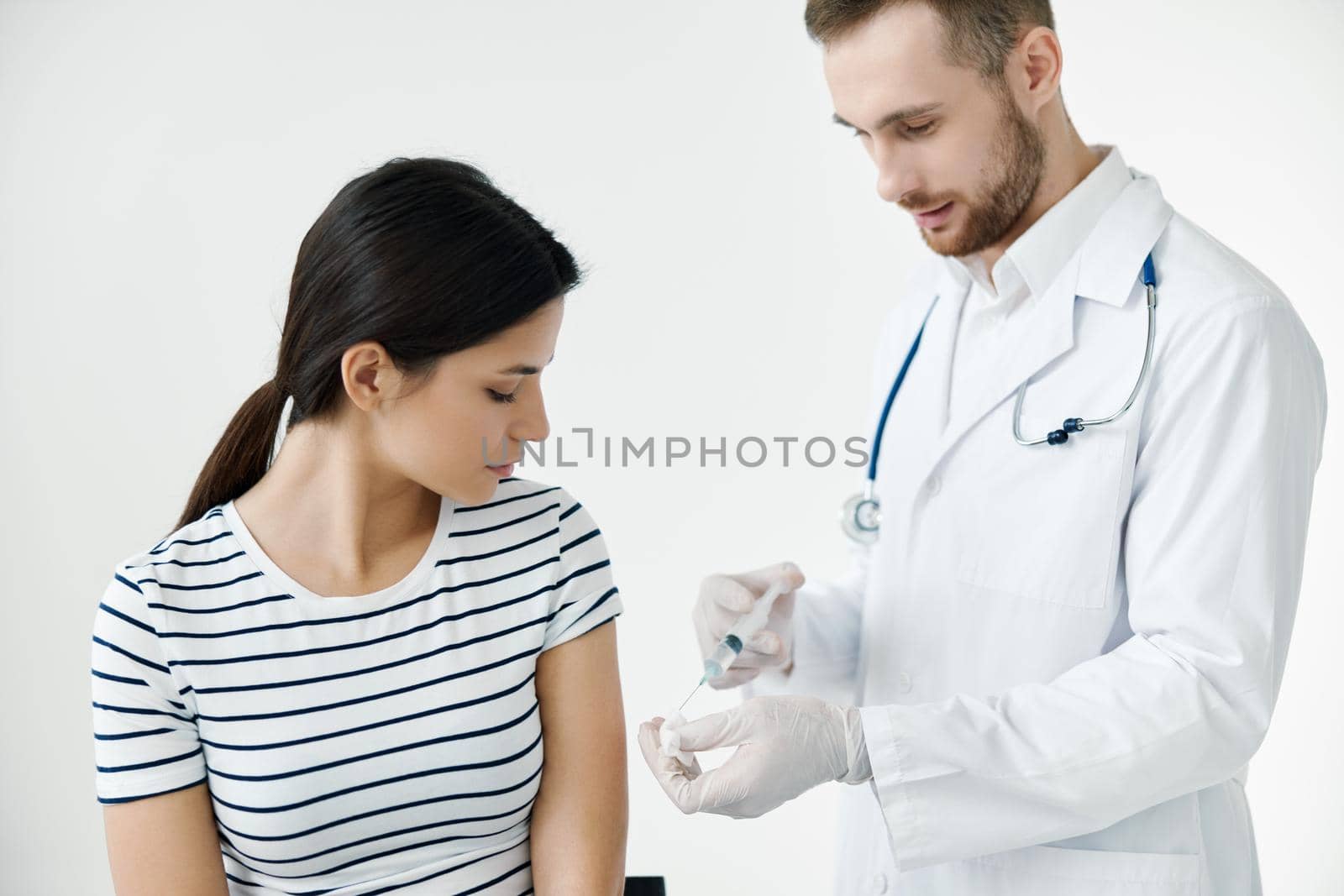 man giving an injection to a patient in the shoulder vaccination health . High quality photo