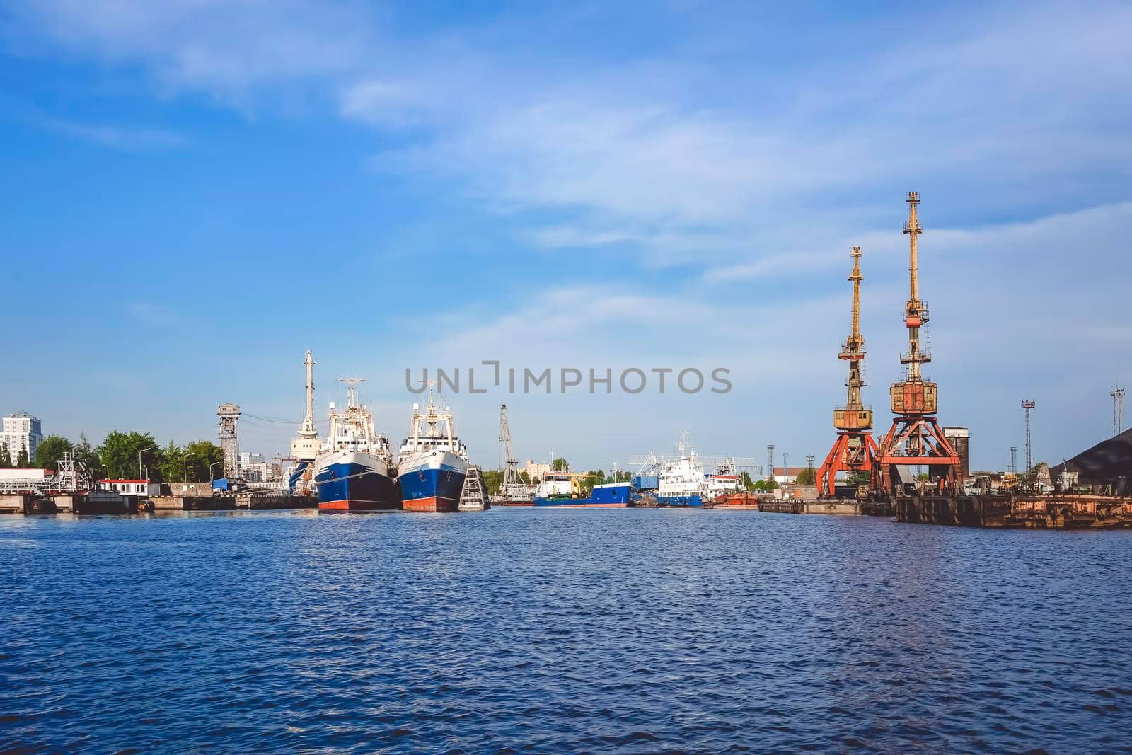 Kaliningrad , Russia. Port of a large Russian city with ships and various equipment on the background of the river.