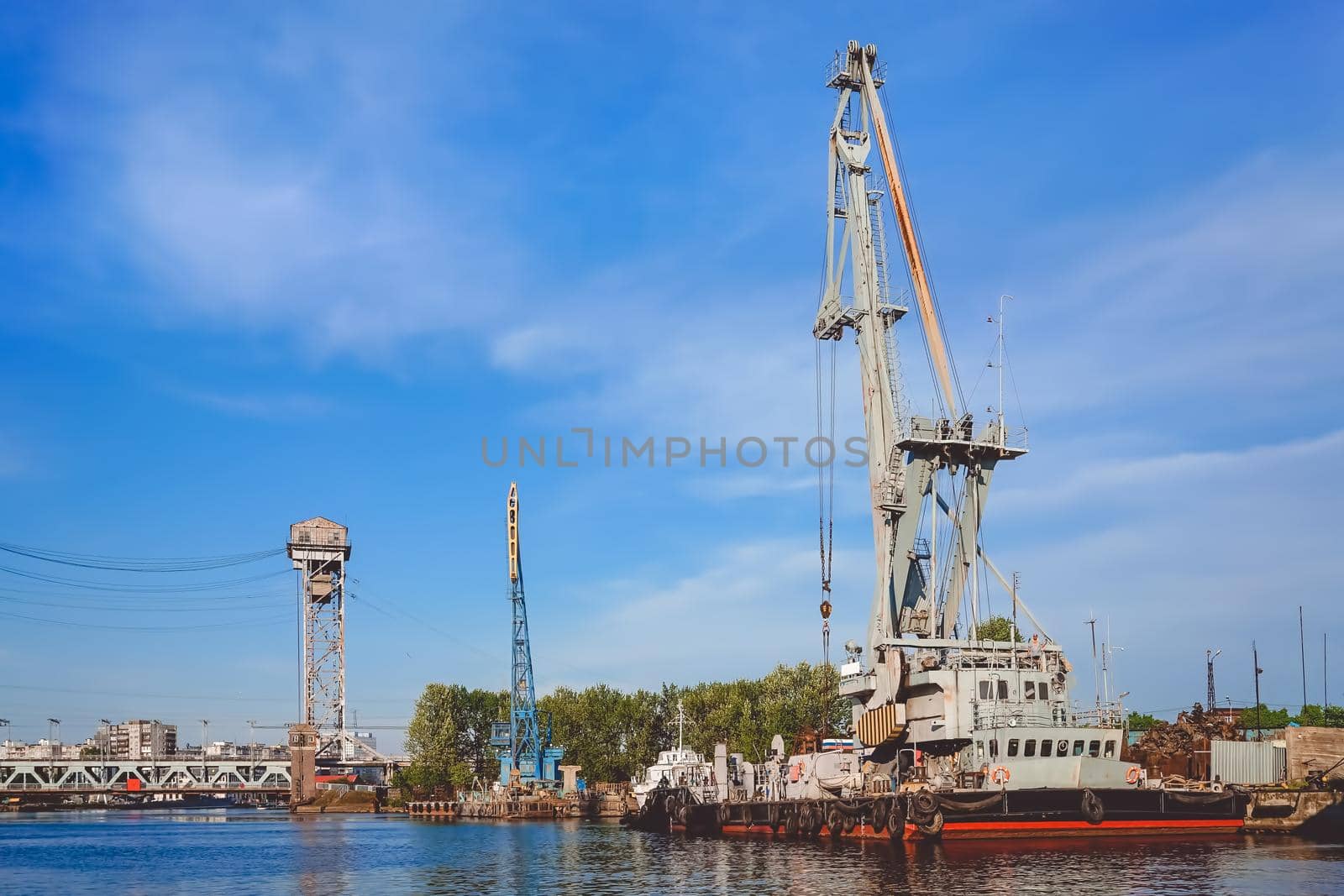 Kaliningrad , Russia. Port of a large Russian city with ships and various equipment on the background of the river.