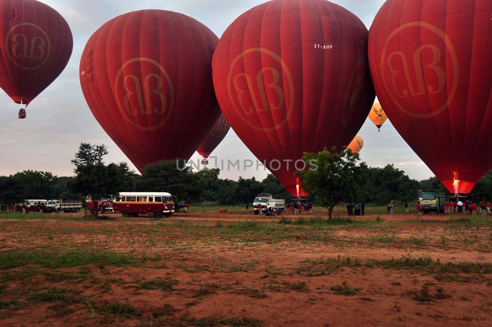 BAGAN, MYANMAR - NOVEMBER 19, 2015: Bright red air balloons on field, View of plenty of red air balloons on ground of spacious terrain. Fly over Mingalazedi Sulamani Shwezigon Ananda Htilominlo