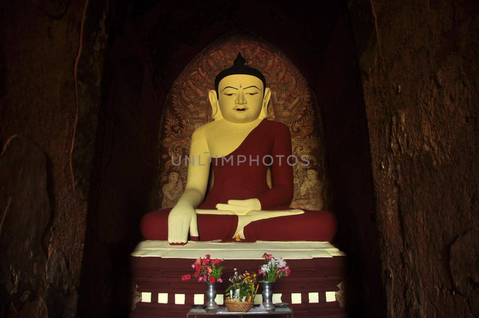 BAGAN, MYANMAR - NOVEMBER 18, 2015: Huge colored statue of Buddha in temple, From below shot of colorful Buddha statue in ornamental temple. Mingalazedi Sulamani Shwezigon Ananda Htilominlo