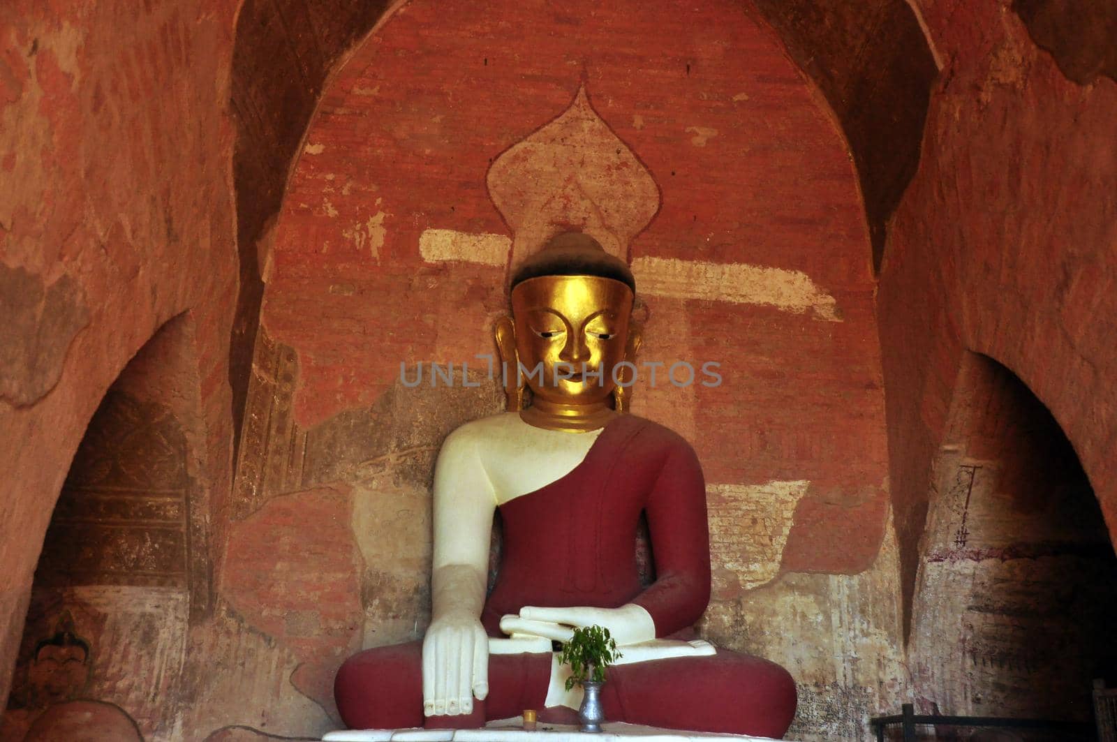 BAGAN, MYANMAR - NOVEMBER 18, 2015: Huge colored statue of Buddha in temple, From below shot of colorful Buddha statue in ornamental temple. Mingalazedi Sulamani Shwezigon Ananda Htilominlo