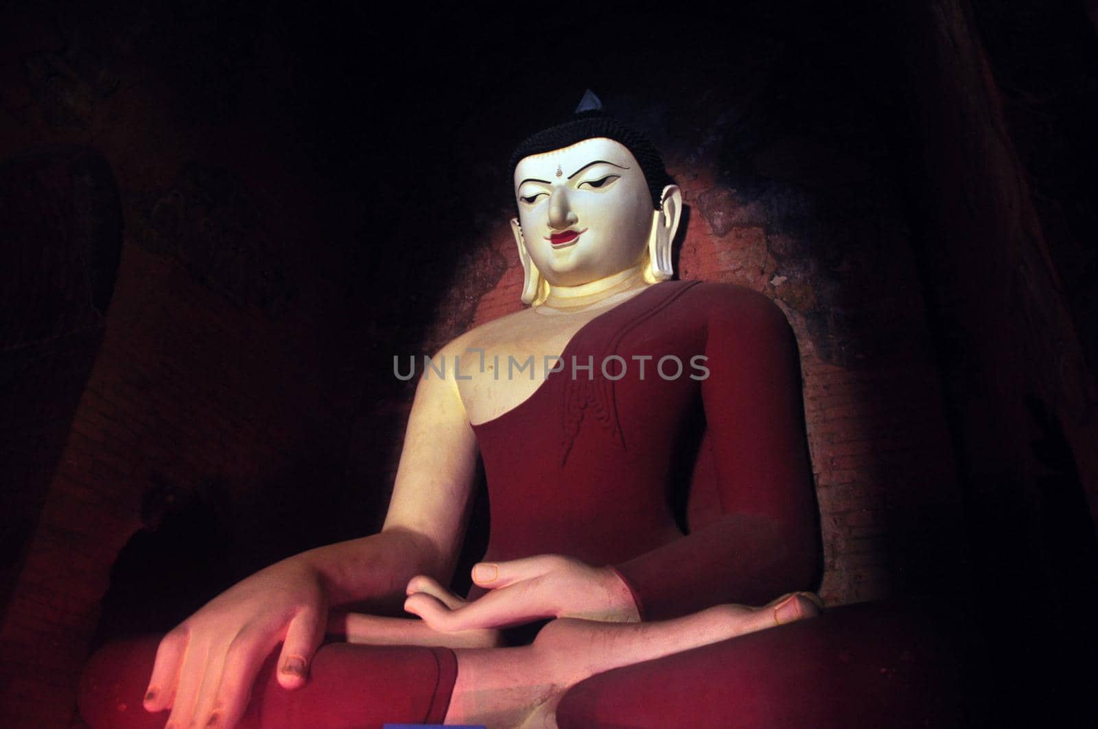 BAGAN, MYANMAR - NOVEMBER 18, 2015: Huge colored statue of Buddha in temple, From below shot of colorful Buddha statue in ornamental temple. Mingalazedi Sulamani Shwezigon Ananda Htilominlo
