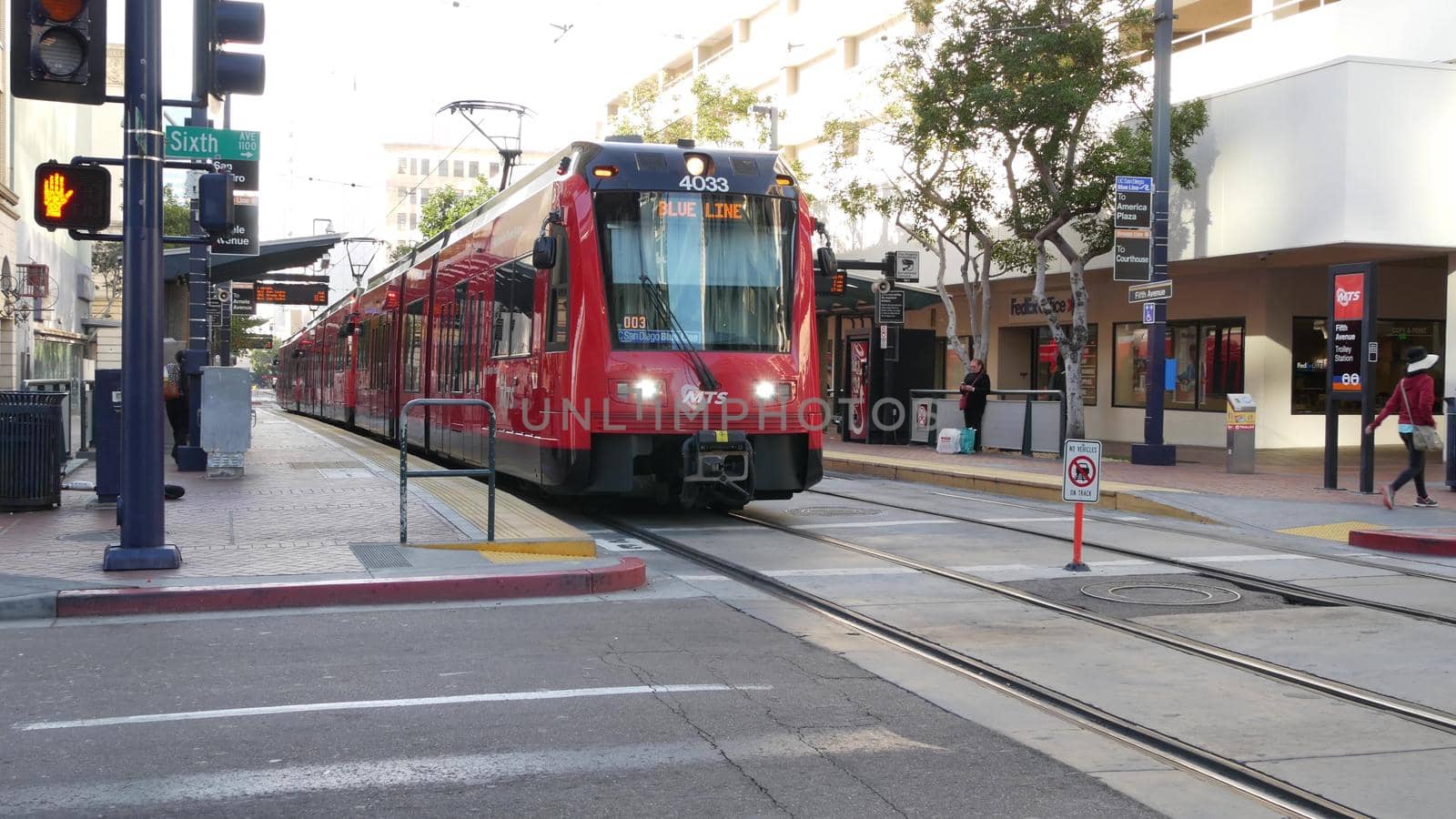 SAN DIEGO, CALIFORNIA USA - 4 JAN 2020: MTS Trolley on tramway, ecological public passenger transportation. Electric tram line station in Gaslamp Quarter. City transport stop on crossroad of downtown.