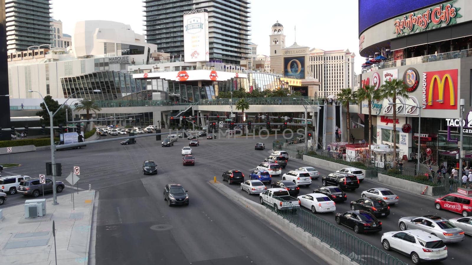 LAS VEGAS, NEVADA USA - 5 MAR 2020: The Strip boulevard with luxury casino and hotels in gambling sin city. Car traffic on road to Fremont street in tourist money playing resort. People walking by DogoraSun