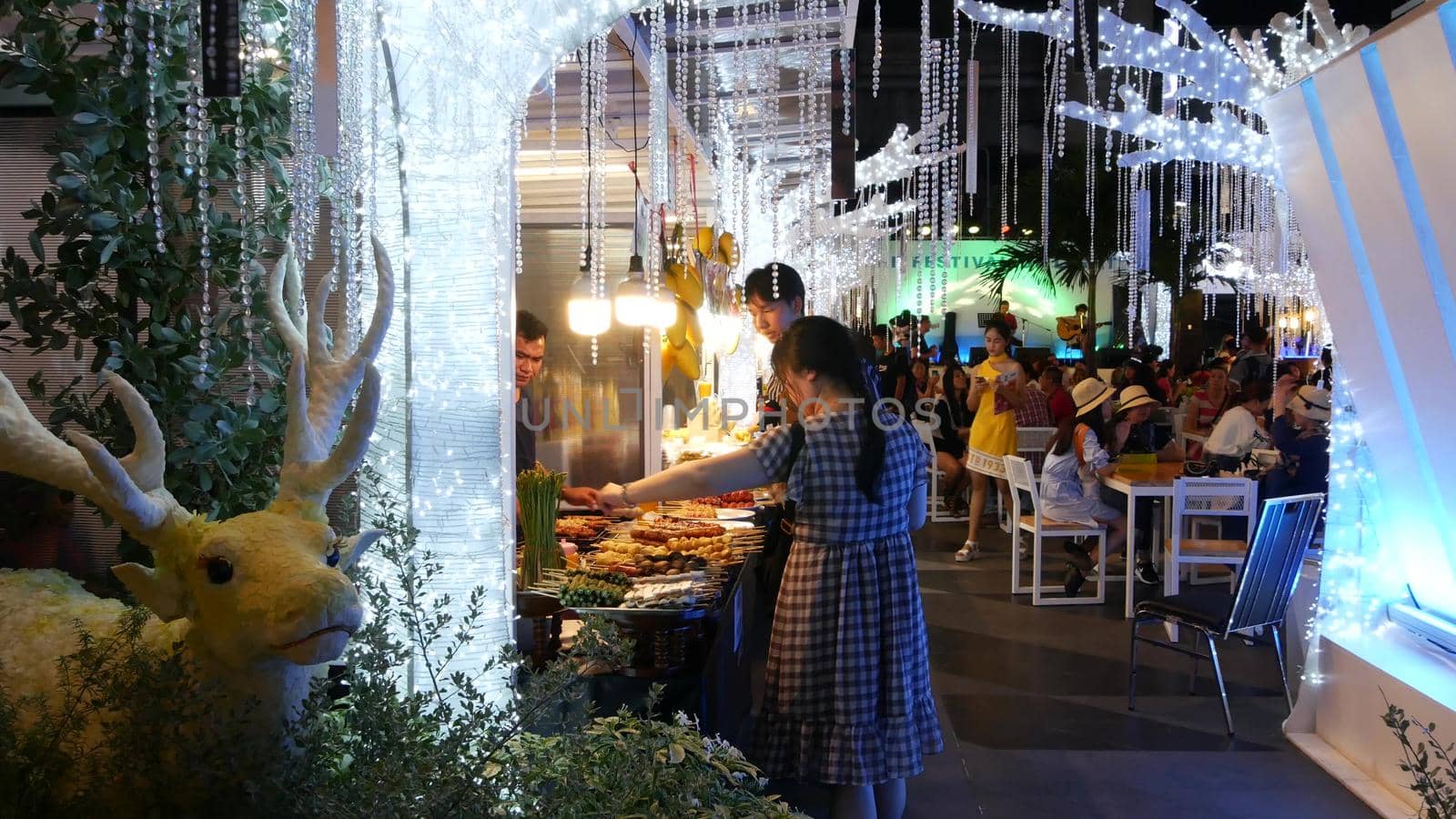 BANGKOK, THAILAND - 18 DECEMBER, 2018: People eating and bying asian thai street fast food in the food court at cafeteria in shopping mall in business centre of city by DogoraSun