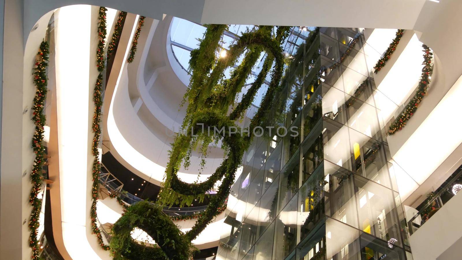 BANGKOK, THAILAND - 18 DECEMBER, 2018 The Emquartier luxury shopping center. Design of mall, green environmentally friendly concept. hanging garden futuristic eco architecture. Modern city. Escalator by DogoraSun