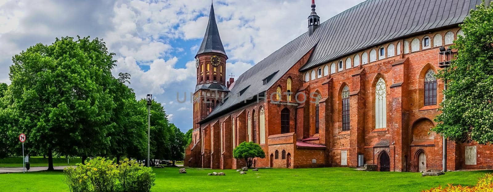 Kaliningrad , Russia. Panorama with a view of the famous Cathedral surrounded by lush summer greenery.