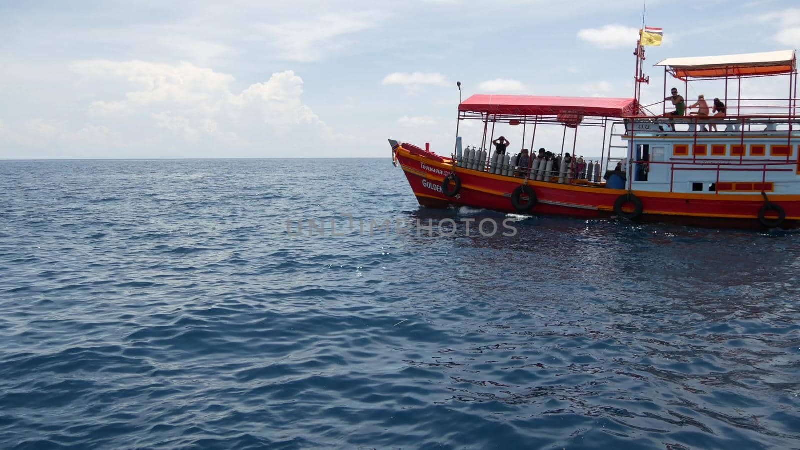 KOH TAO ISLAND, THAILAND - 29 JUNE 2019 Diving boat floating on surface of rippling sea in paradise exotic resort. Sports entertainment for tourists, diving deep under water with equipment. by DogoraSun