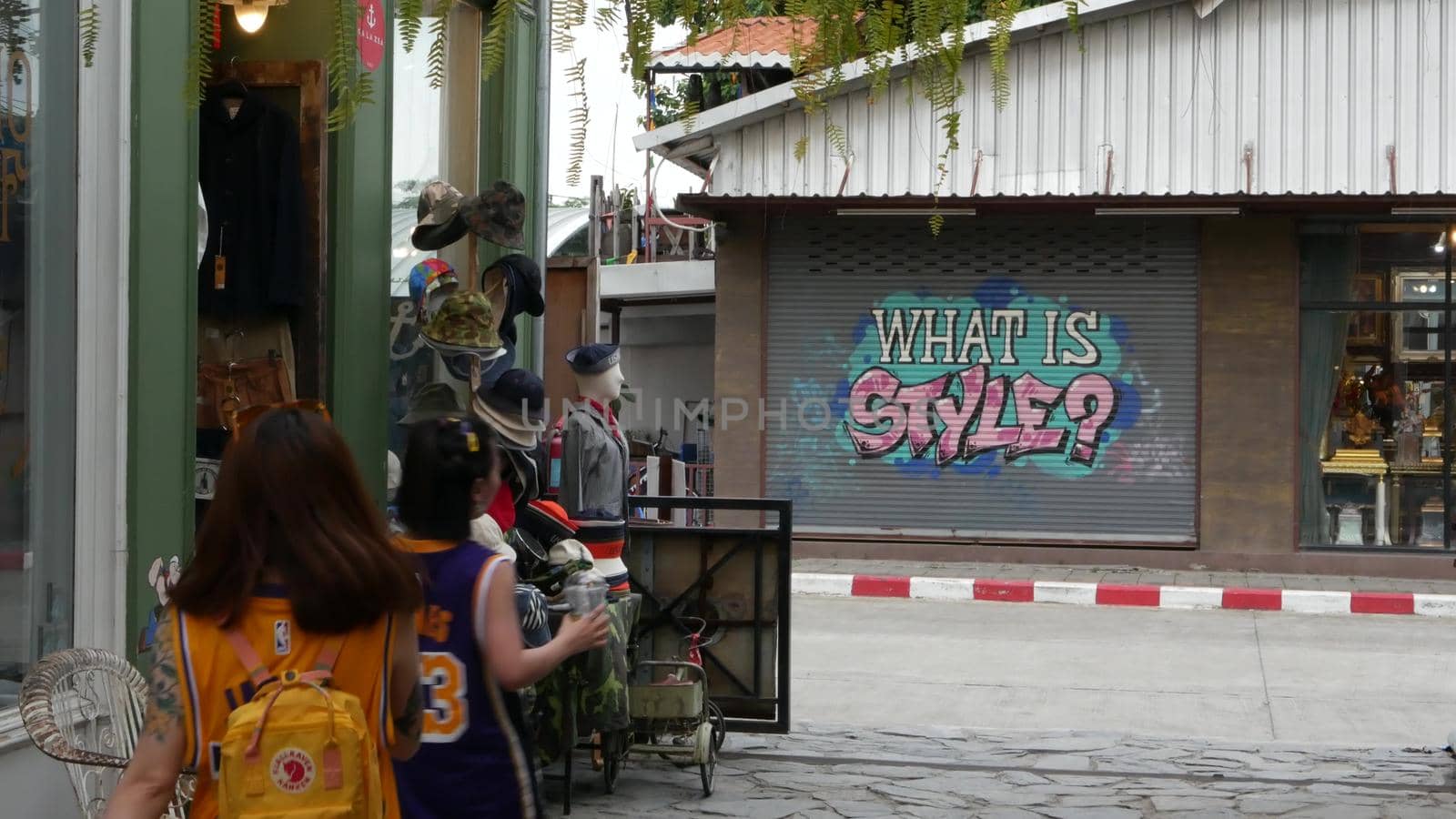 BANGKOK, THAILAND - 10 JULY, 2019: People walking at the Camp vintage flea market near Chatuchak. Design of retro style boutique art shops of antiques. Decoration of popular fashion city landmark