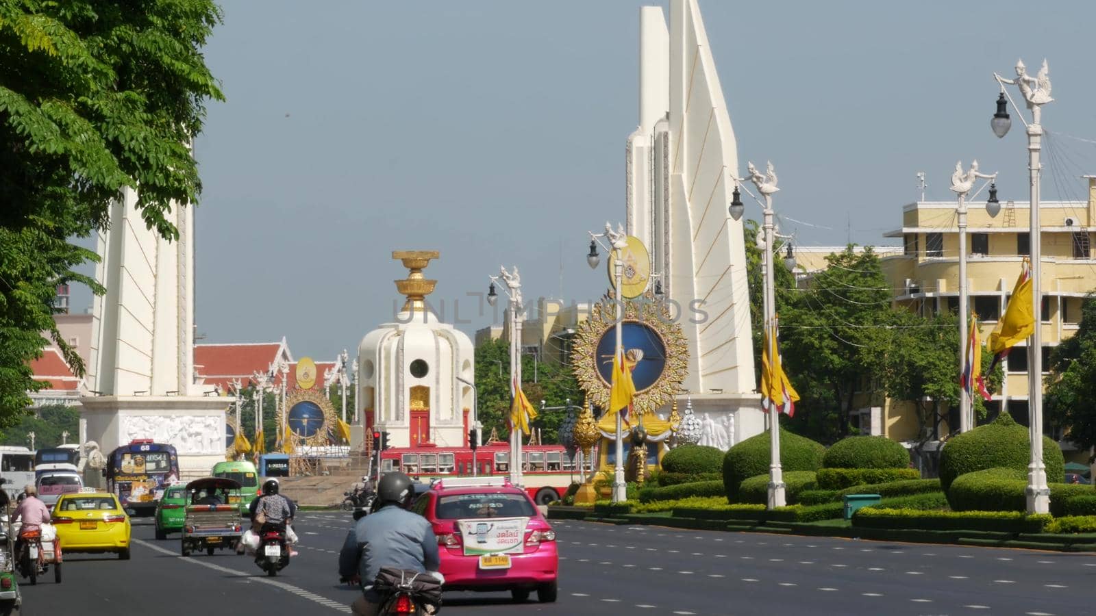 BANGKOK, THAILAND - 11 JULY, 2019: Rush hour traffic near Democracy Monument in capital. Famous asian landmark and travel destination. Democratic and patriotic symbol and public transport in downtown.