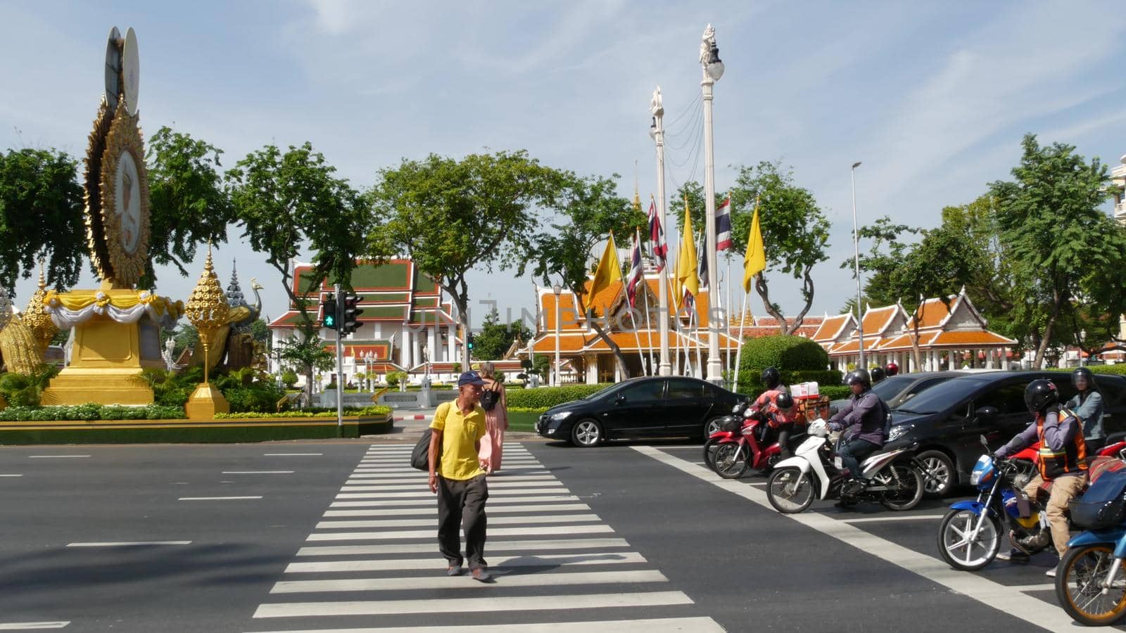 BANGKOK, THAILAND - 11 JULY, 2019: Rush hour traffic near Wat Saket in capital. Famous asian landmark and travel destination. Ancient religious monastery and public transport on the road in downtown