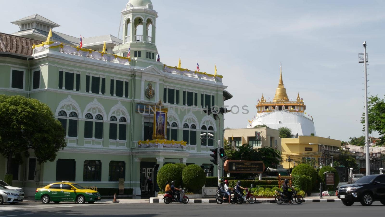 BANGKOK, THAILAND - 11 JULY, 2019: Rush hour traffic near Wat Saket in capital. Famous asian landmark and travel destination. Ancient religious monastery and public transport on the road in downtown