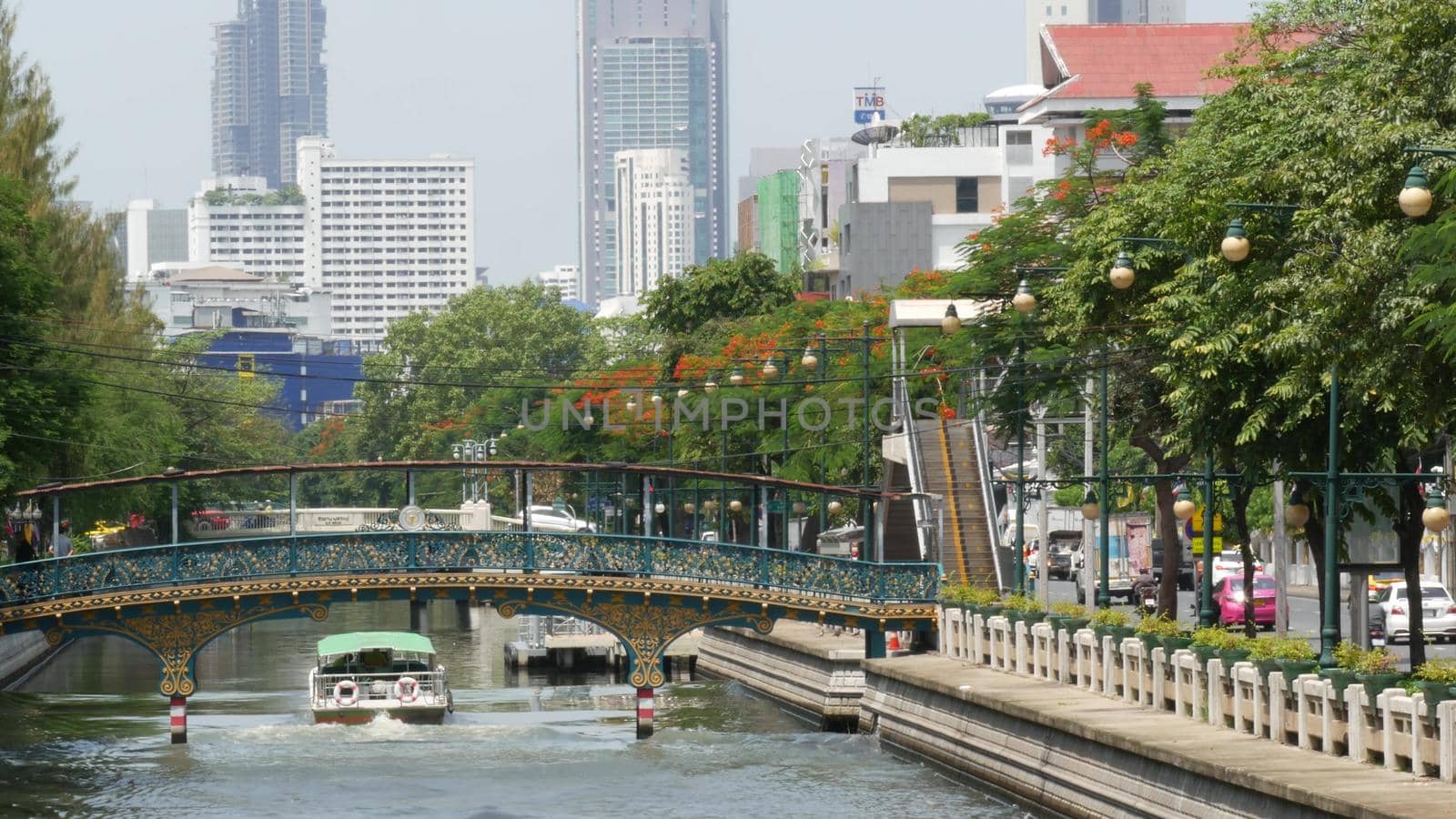 BANGKOK, THAILAND, 11 JULY 2019: Canal as classic typical water way for public passengers transportation. Street city life on khlong. Local people use boat as traditional transport during traffic jam.