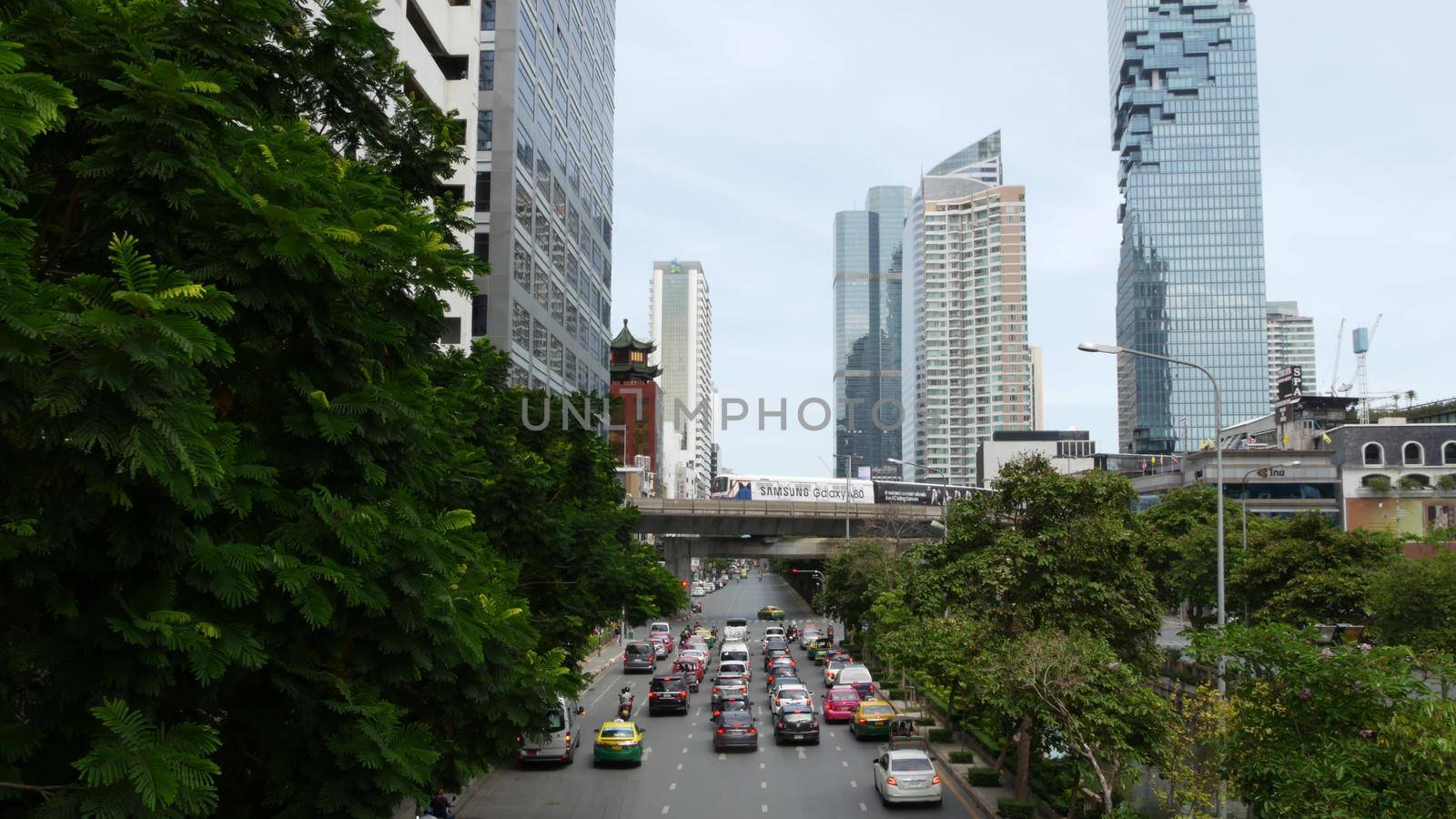 BANGKOK, THAILAND - 13 JULY, 2019: Mahanakhon King Power skyscraper in modern Sathorn financial business district. Maha Nakhon - tallest futuristic building. Rush hour traffic, cars and bts skytrain.