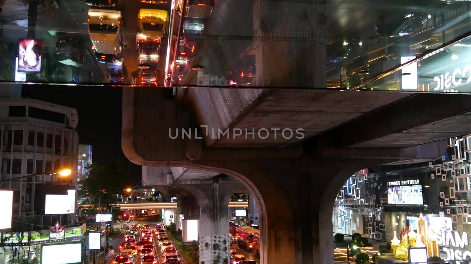 BANGKOK, THAILAND, 13 JULY 2019 Rush hour urban vehicles traffic near MBK, Siam Discovery and Paragon Square reflected upside down in mirror. Downtown modern city life colorful perspective reflection