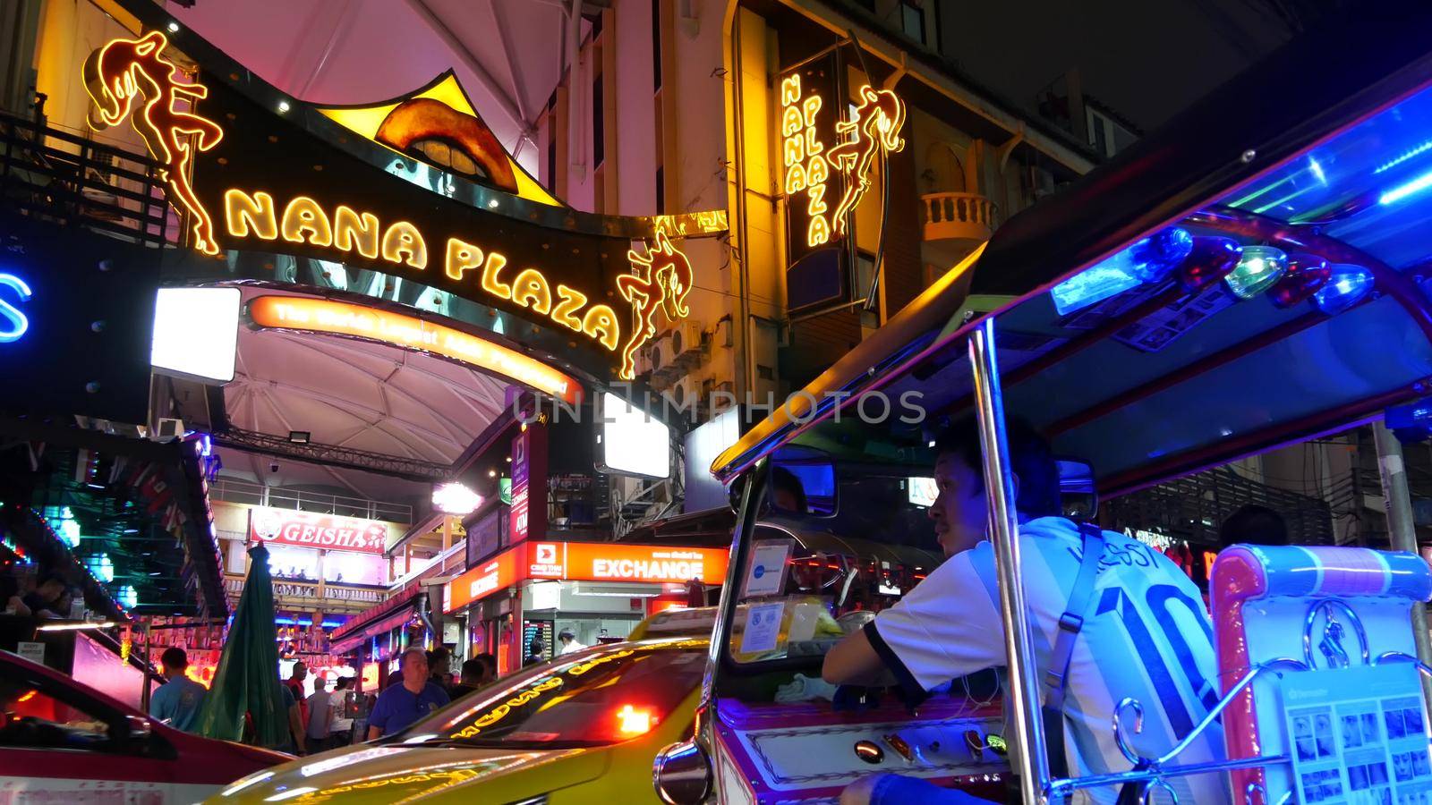 BANGKOK, THAILAND,13 JULY 2019 Vivid neon signs glowing, Nana Plaza street. Nightlife in erotic Red light district soi. Illuminated bar and adult go-go show club. Night life tourist entertainment