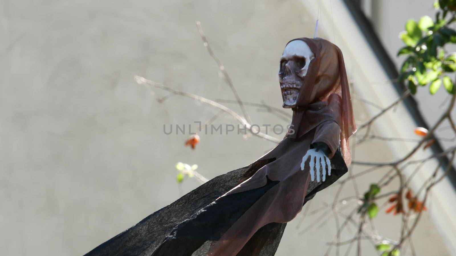 LOS ANGELES, CALIFORNIA, USA - 29 OCT 2019: Scary festival decorations of a house, Happy Halloween holiday. Classic garden with Pumpkin, Bones and Skeleton. Traditional party decor. American culture.