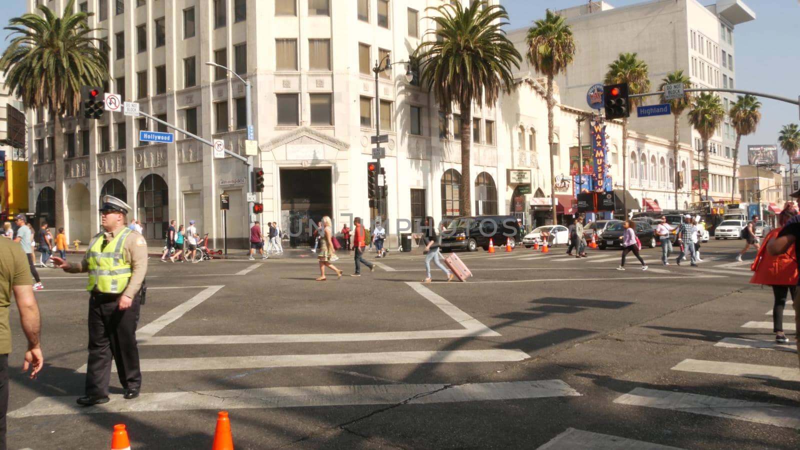 LOS ANGELES, CALIFORNIA, USA - 7 NOV 2019: Walk of fame promenade, Hollywood boulevard in LA city. Pedastrians walking on sidewalk of street. Entertainment and cinema industry iconic tourist landmark.