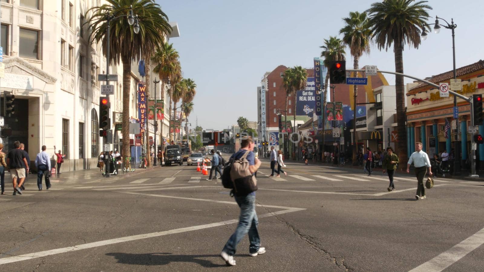 LOS ANGELES, CALIFORNIA, USA - 7 NOV 2019: Walk of fame promenade, Hollywood boulevard in LA city. Pedastrians walking on sidewalk of street. Entertainment and cinema industry iconic tourist landmark.