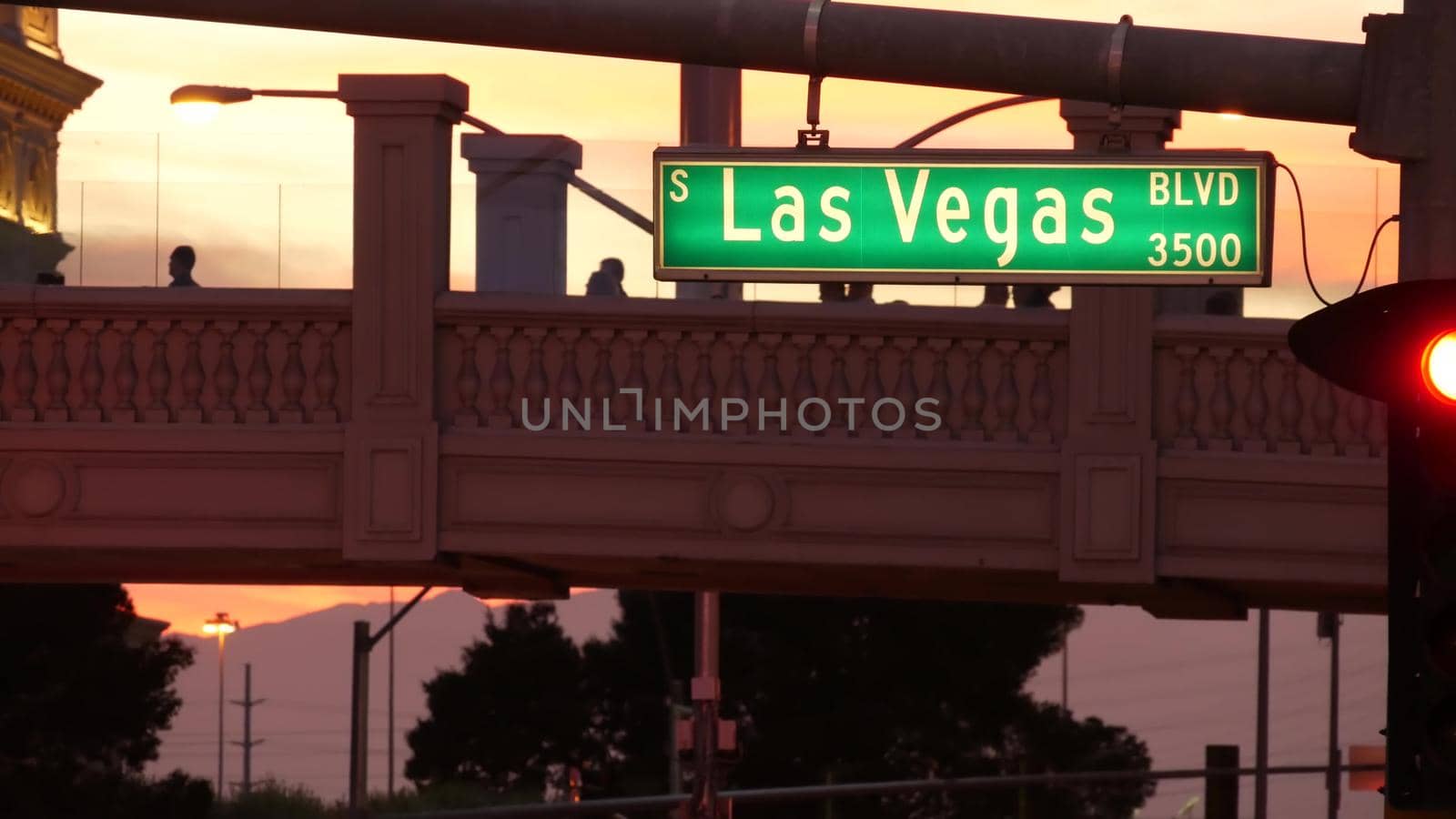 LAS VEGAS, NEVADA USA - 13 DEC 2019: Traffic sign glowing on The Strip in fabulous sin city. Iconic signboard on the road to Fremont street. Illuminated symbol of casino, money playing and betting by DogoraSun