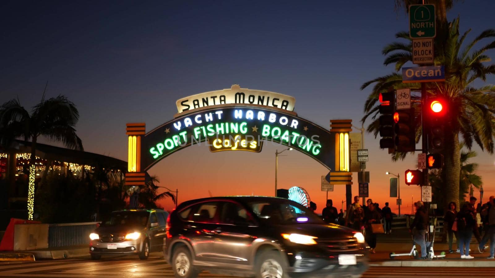 SANTA MONICA, LOS ANGELES CA USA - 19 DEC 2019: Summertime iconic vintage symbol. Classic illuminated retro sign on pier. California summertime aesthetic. Glowing lettering on old-fashioned signboard.
