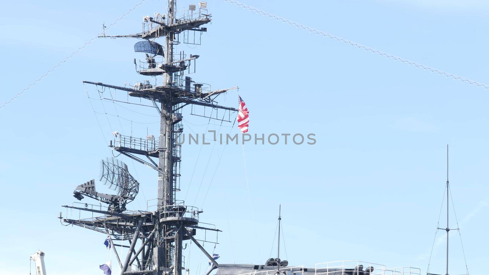 SAN DIEGO, CALIFORNIA USA - 4 JAN 2020: Radar of USS Midway military aircraft carrier, historic war ship. Naval army battleship with American flag. Maritime steel warship in port, navy fleet symbol by DogoraSun