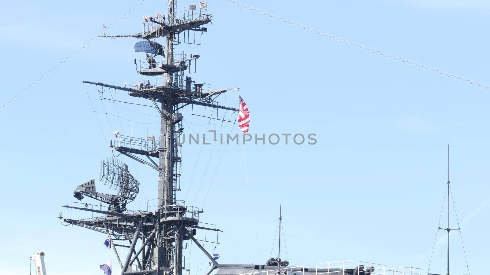 SAN DIEGO, CALIFORNIA USA - 4 JAN 2020: Radar of USS Midway military aircraft carrier, historic war ship. Naval army battleship with American flag. Maritime steel warship in port, navy fleet symbol.