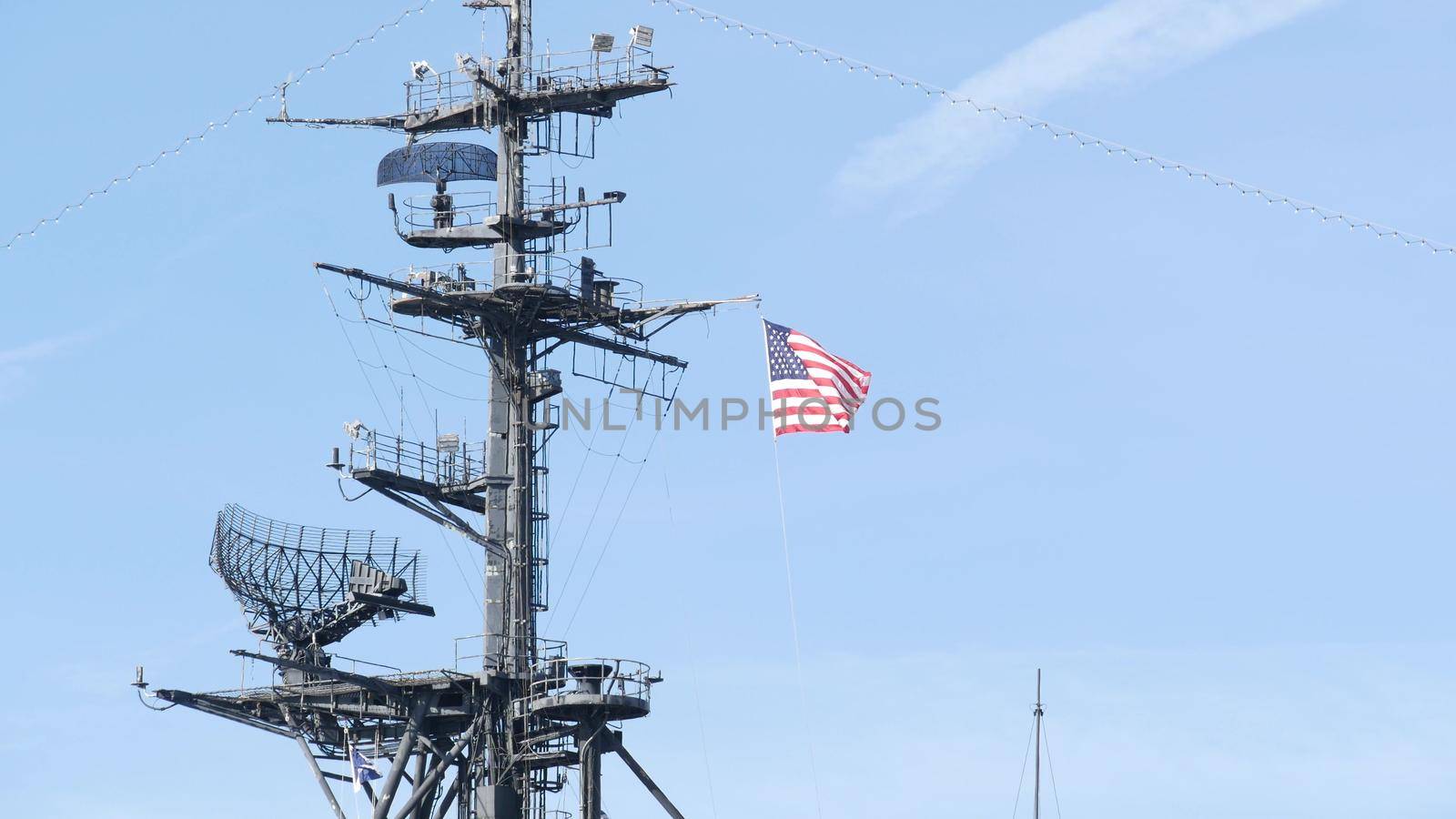 SAN DIEGO, CALIFORNIA USA - 4 JAN 2020: Radar of USS Midway military aircraft carrier, historic war ship. Naval army battleship with American flag. Maritime steel warship in port, navy fleet symbol by DogoraSun