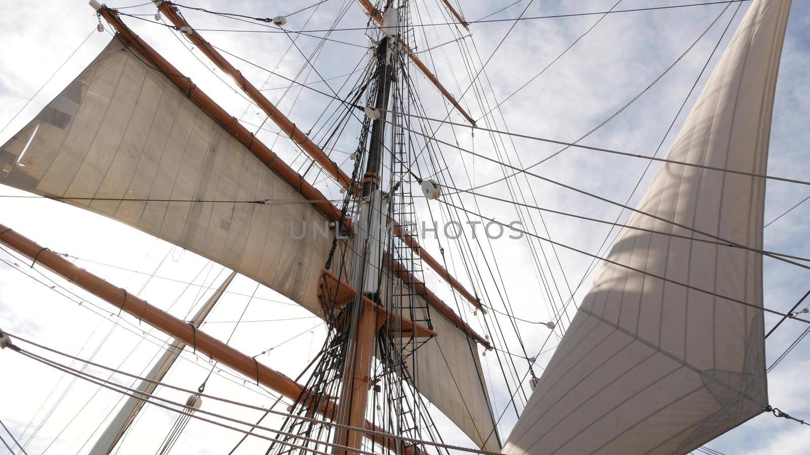 SAN DIEGO, CALIFORNIA USA - 30 JAN 2020: Retro sailing ship Star of India, full rigged wooden masts of Maritime Museum. Historic British frigate with white sails and ropes. Old large barque sailboat.