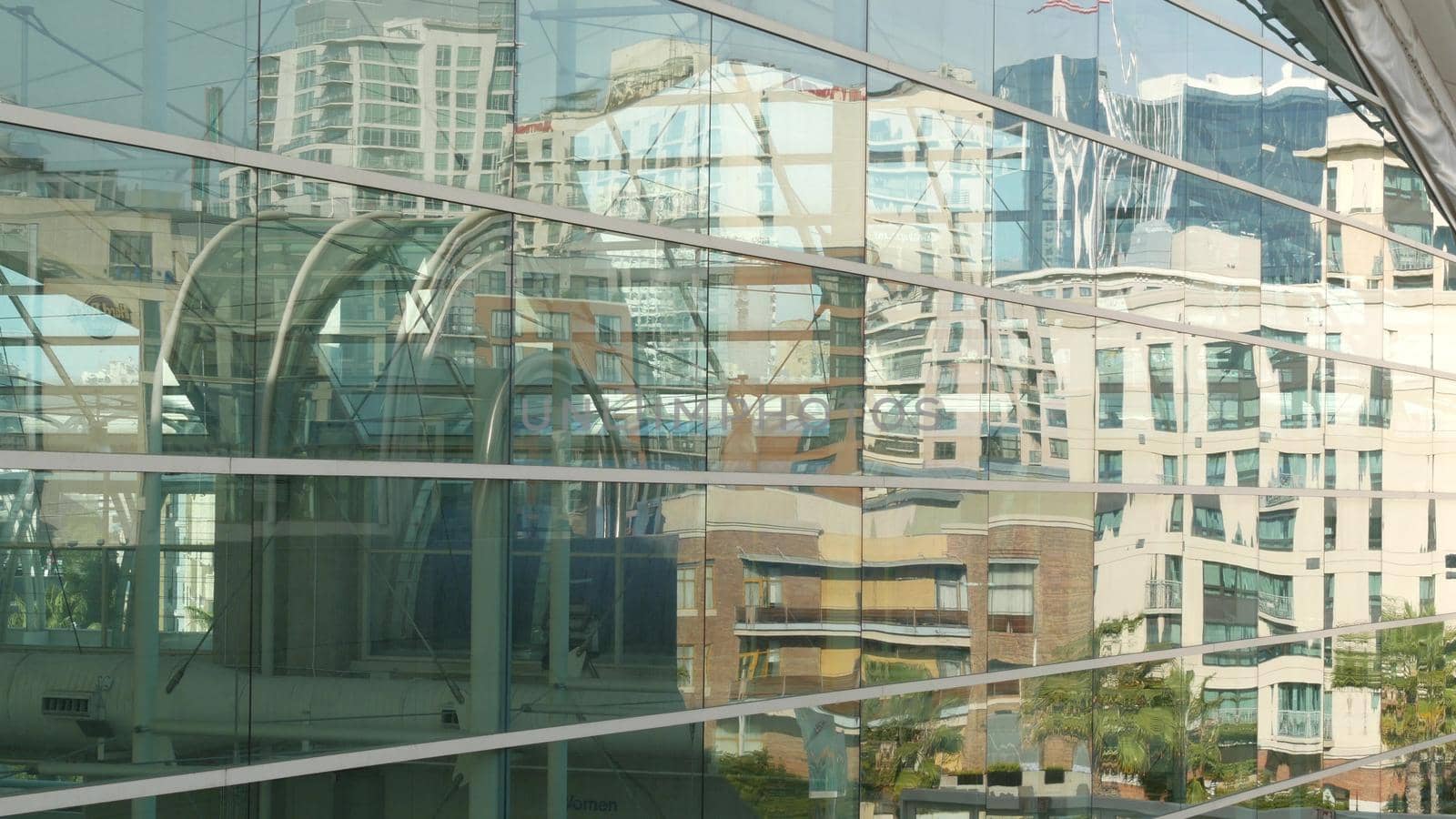 SAN DIEGO, CALIFORNIA USA - 13 FEB 2020: Contemporary Convention Center building, reflection of urban skyline in mirror glass wall. Highrise skyscrapers of Gaslamp Quarter in downtown of metropolis.