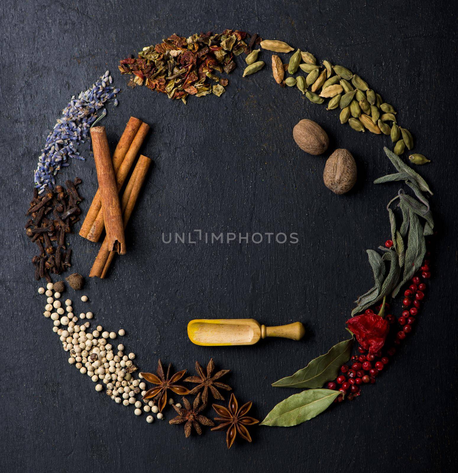 Various spices spoons on black table. Top view with copy space by aprilphoto