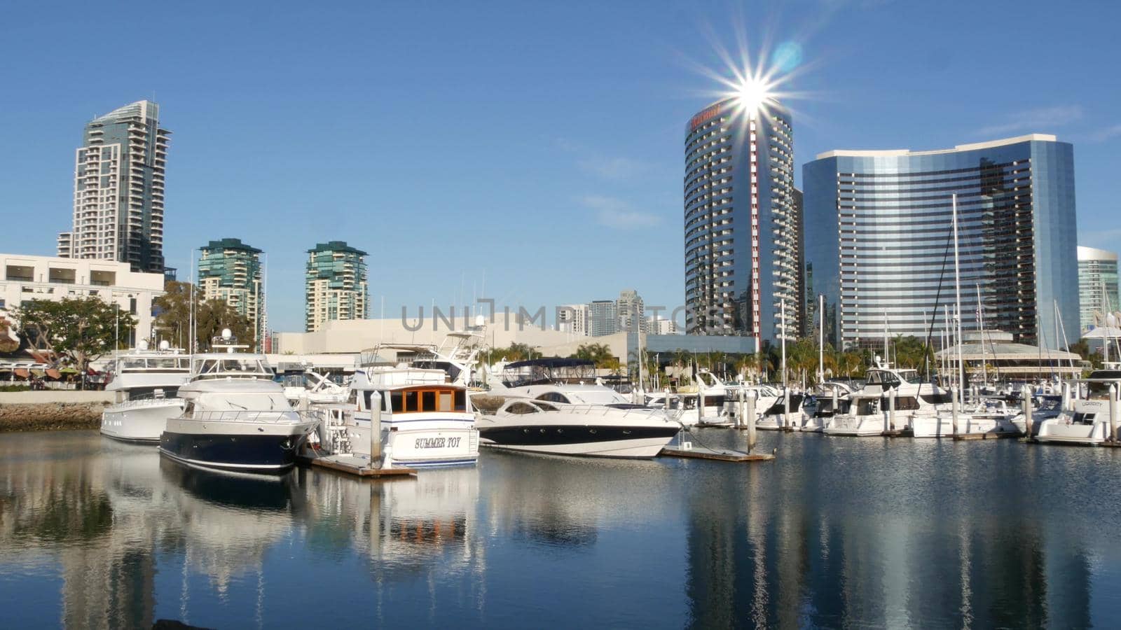 SAN DIEGO, CALIFORNIA USA - 13 FEB 2020: Embarcadero marina park near USS Midway and Convention Center. Marriott hotel near Seaport Village. Luxury yachts, highrise skyscrapers of urban skyline by DogoraSun