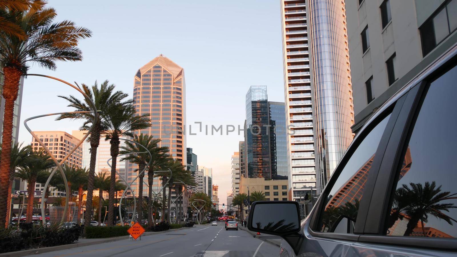 SAN DIEGO, CALIFORNIA USA - 13 FEB 2020: Pedestrians, traffic and highrise buildings in city downtown. Street life of american metropolis. Urban Broadway street, transport and citizens near Santa Fe.