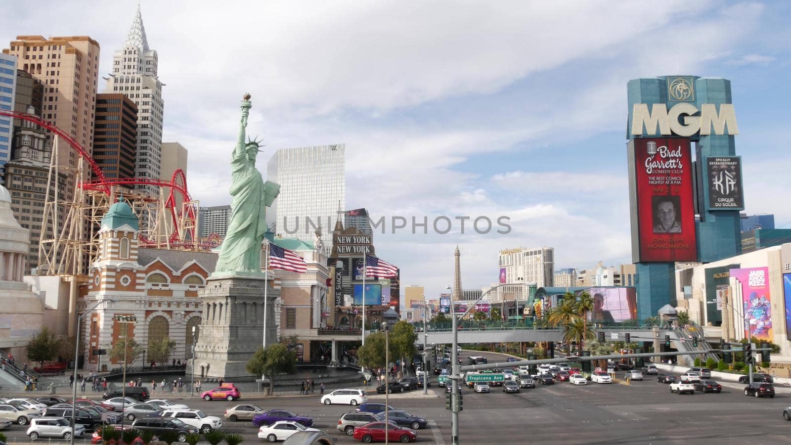 LAS VEGAS, NEVADA USA - 7 MAR 2020: The Strip boulevard with luxury casino in gambling sin city. Car traffic on road to Fremont street, tourist money playing resort. New York hotel and Liberty Statue by DogoraSun