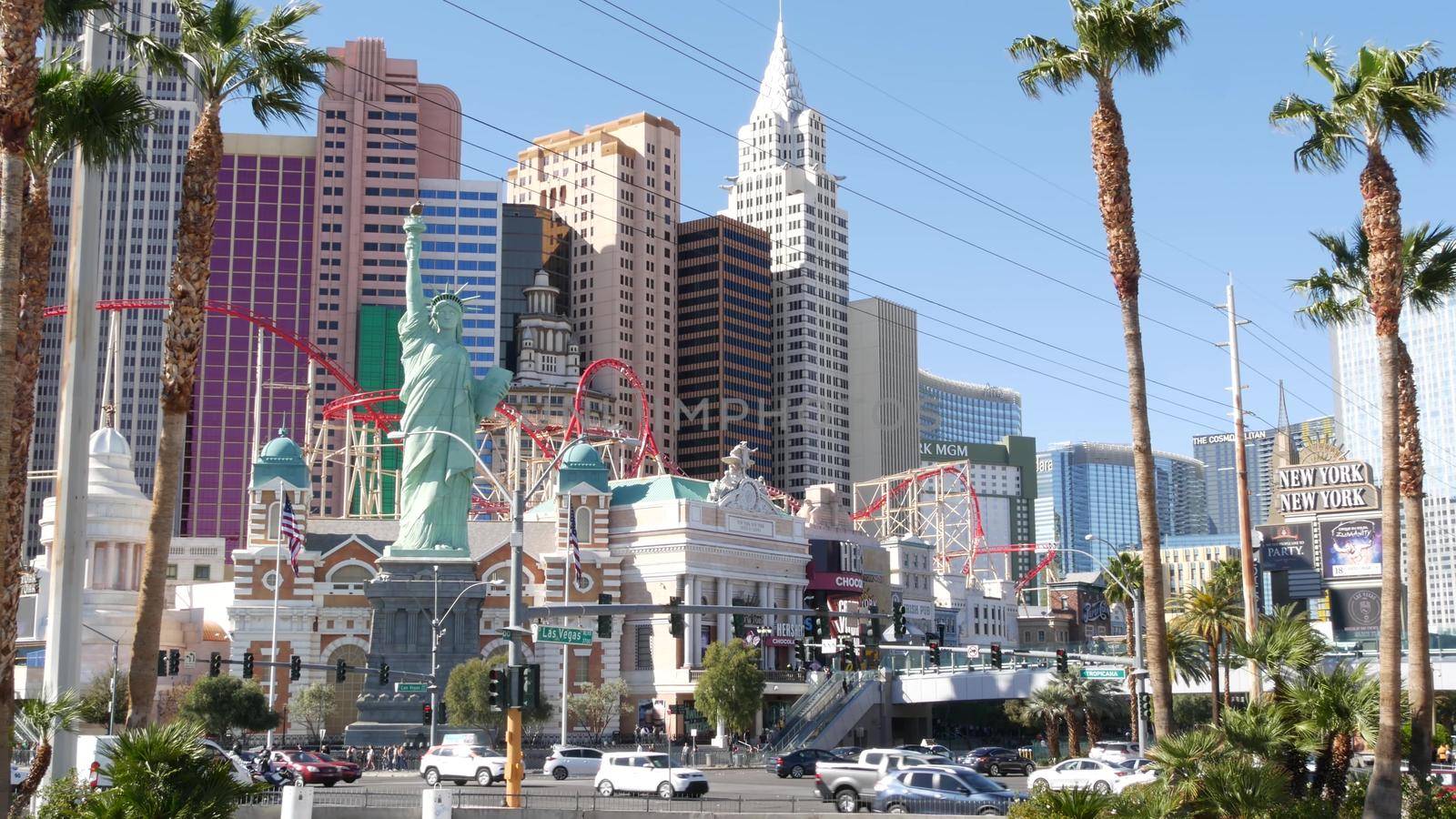 LAS VEGAS, NEVADA USA - 8 MAR 2020: The Strip boulevard with luxury casino in gambling sin city. Car traffic on road to Fremont street, tourist money playing resort. New York hotel and Liberty Statue.