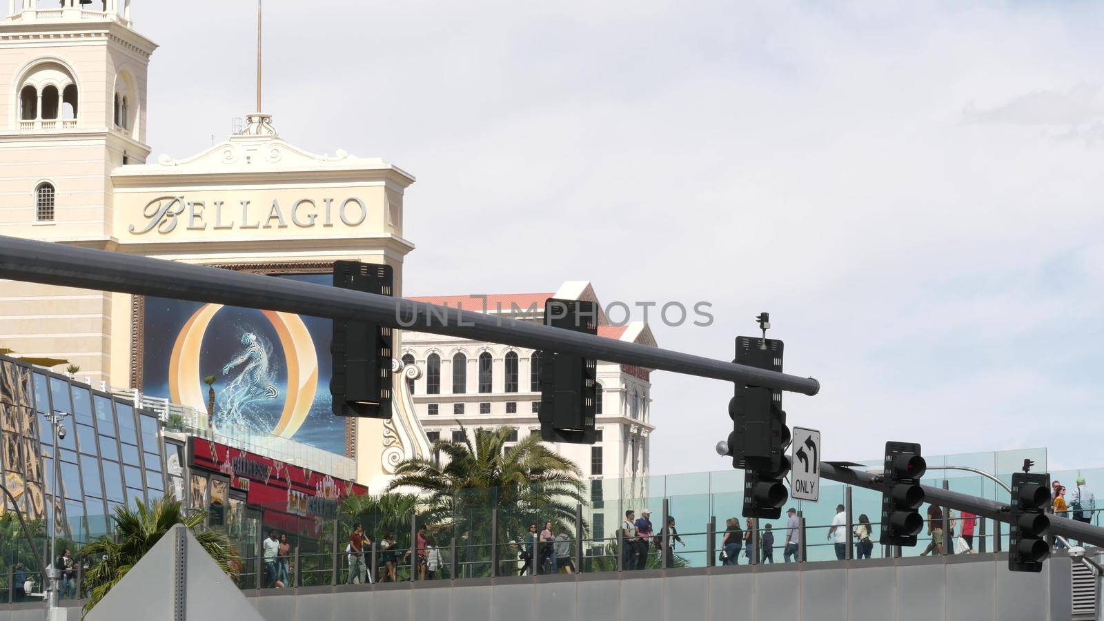 LAS VEGAS, NEVADA USA - 7 MAR 2020: People on pedestrian skyway. Multicultural men and women walk on skybridge. Crowd of citizens on pedway. Diversity of multiracial tourists on skywalk in metropolis by DogoraSun