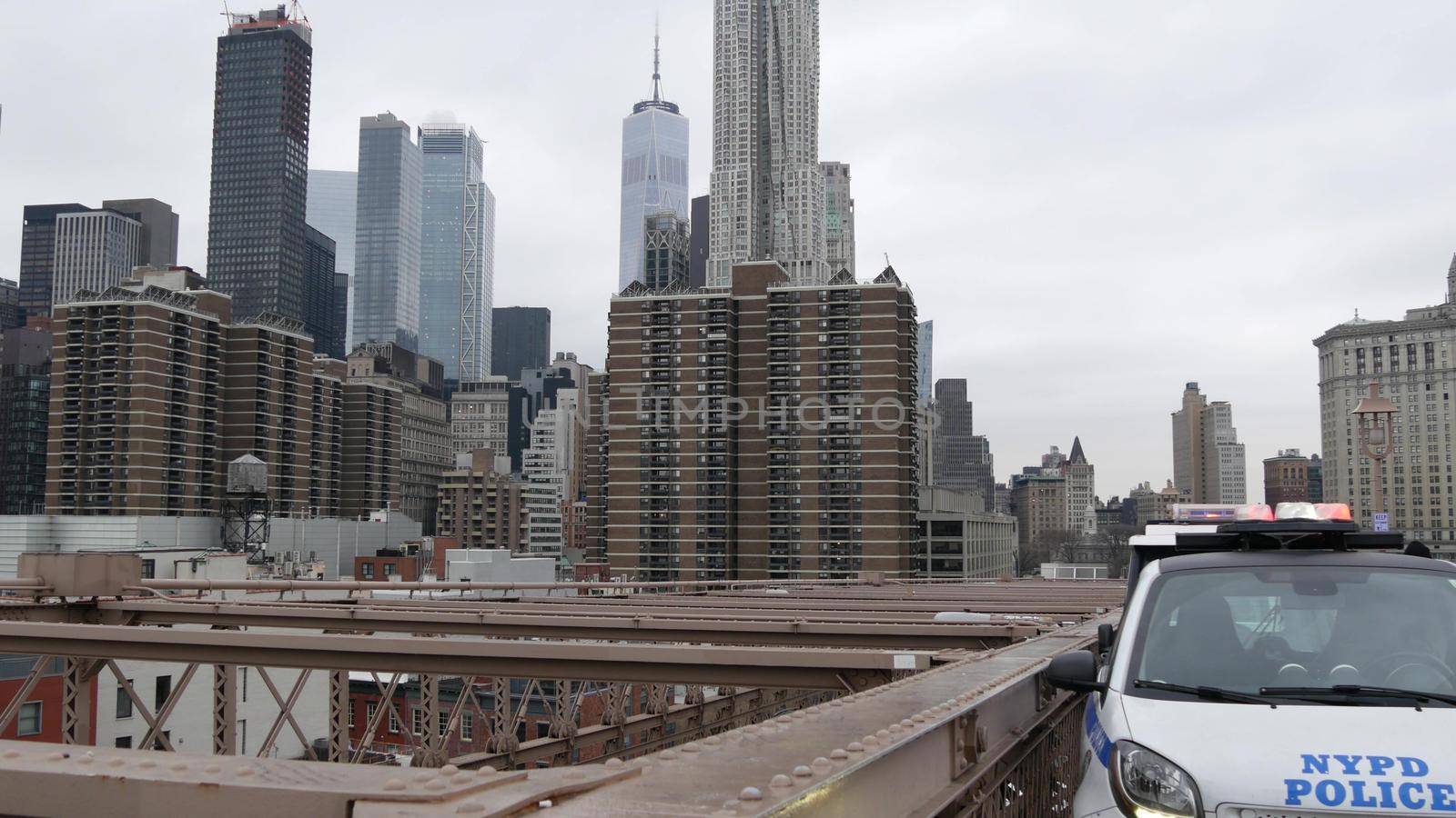 NEW YORK CITY, USA - 12 MAR 2020: Emergency siren glowing, 991 police patrol car on Brooklyn bridge. NYPD auto, symbol of crime prevention and safety in Manhattan. Metropolis security and protection.
